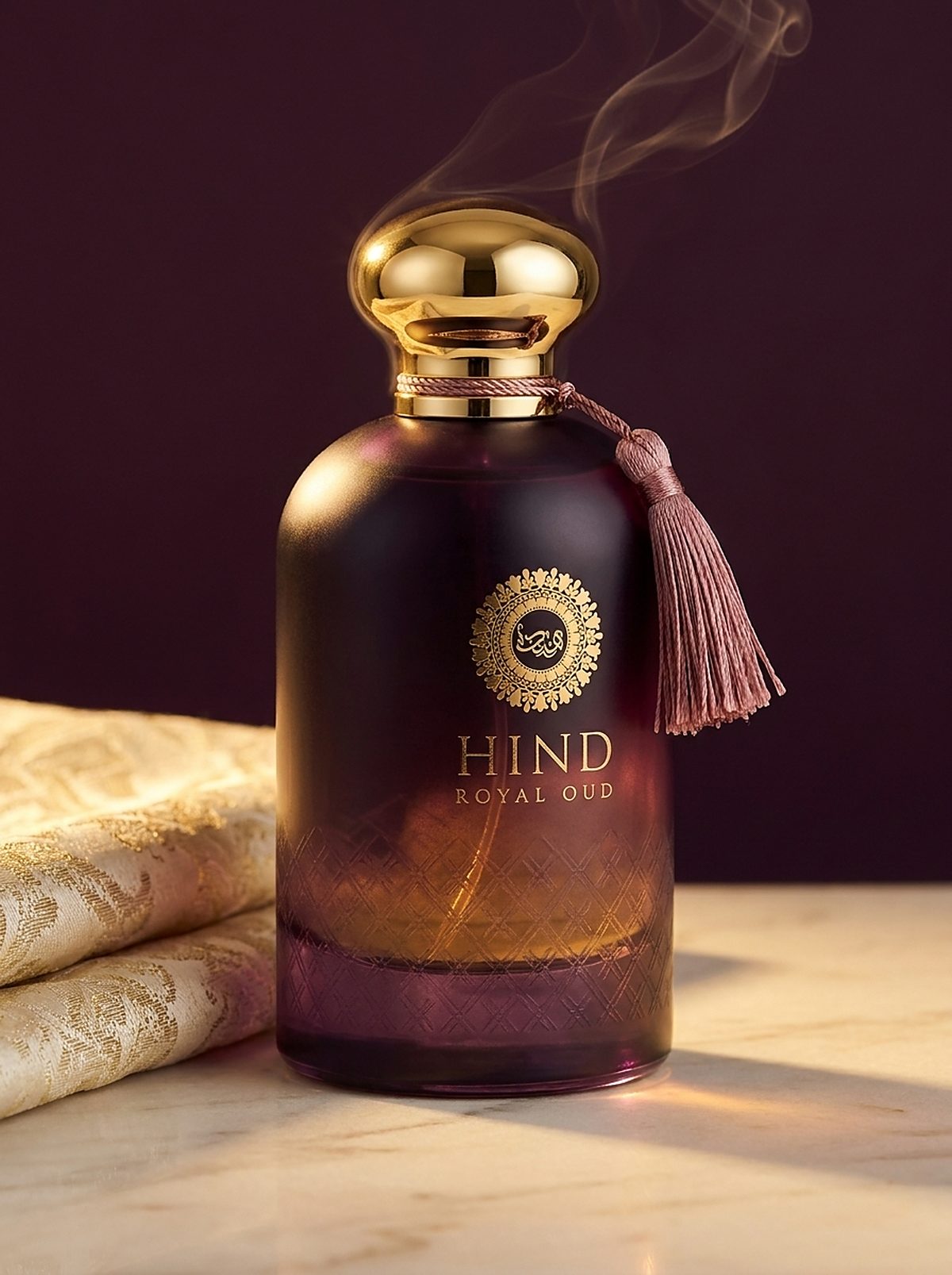 Hind Royal Oud aubergine eau de parfum with a domed gold cap and rose tassel, smoke curling behind it